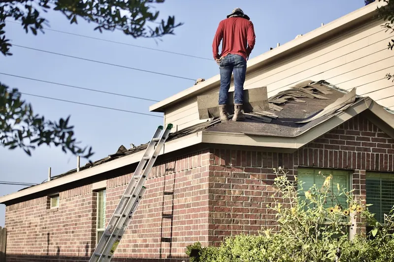 Professional roofer working on a residential roof in Fairway Estates PD
